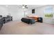 Spacious main bedroom with a large bed, ceiling fan, and natural light, featuring a crib and a calming color scheme at 12107 Nouveau Ave, Spring Hill, FL 34610