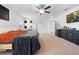Bright main bedroom has carpet, a cozy bed, decor, a television, and access to the en-suite bath at 12107 Nouveau Ave, Spring Hill, FL 34610