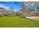 Charming single-story home featuring a well-manicured lawn, mature landscaping, and a three-car garage at 122 Falling Water Dr, Brandon, FL 33511