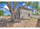 The home has a spacious backyard with a large mature tree, offering shade and privacy at 12653 Longcrest Dr, Riverview, FL 33579