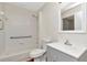 Bathroom featuring a white vanity, tiled shower with grab bar, and updated fixtures at 12653 Longcrest Dr, Riverview, FL 33579