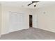 This bedroom features plush gray carpet, a ceiling fan, and a closet with folding doors at 12653 Longcrest Dr, Riverview, FL 33579