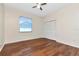 Bright bedroom with hardwood floors, a window, and a double-door closet at 12653 Longcrest Dr, Riverview, FL 33579