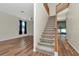 Foyer featuring wood flooring, staircase, and a view into an adjacent living space at 12653 Longcrest Dr, Riverview, FL 33579