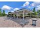 A community gazebo offering shelter with picnic tables, surrounded by lounge chairs at 12653 Longcrest Dr, Riverview, FL 33579