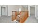 This carpeted upstairs hallway features wooden railings at 12653 Longcrest Dr, Riverview, FL 33579
