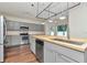 Well-equipped kitchen showcasing stainless steel appliances, gray cabinets, and butcher block countertops at 12653 Longcrest Dr, Riverview, FL 33579