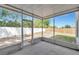 The screened porch looks out onto the fenced-in yard with trees and partial shade at 12653 Longcrest Dr, Riverview, FL 33579