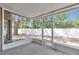 This screened porch provides an outdoor experience with a view of the backyard's mature trees at 12653 Longcrest Dr, Riverview, FL 33579