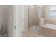 Bathroom showcasing a tiled shower, separate tub, and tile floors at 13423 Lake Monroe Pl, Riverview, FL 33579