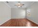 This bedroom features hardwood floors, a ceiling fan, and a bright window at 13423 Lake Monroe Pl, Riverview, FL 33579