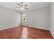 Bedroom with hardwood flooring, neutral paint, a ceiling fan, and a window with lots of natural light at 13423 Lake Monroe Pl, Riverview, FL 33579