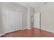 Bedroom with hardwood flooring, a closet with bi-fold doors, and neutral colored paint at 13423 Lake Monroe Pl, Riverview, FL 33579