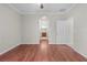 Bedroom with hardwood flooring, neutral paint, and an arched entryway at 13423 Lake Monroe Pl, Riverview, FL 33579
