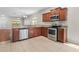 Kitchen features stainless steel appliances, tile flooring, granite countertops, and wood cabinets at 13423 Lake Monroe Pl, Riverview, FL 33579