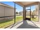 Screened lanai perfect for outdoor seating with a view of the backyard and surrounding neighborhood at 13423 Lake Monroe Pl, Riverview, FL 33579