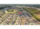 A picturesque aerial view of a residential community, highlighting the layout and surrounding landscape at 14434 Scottburgh Glen Dr, Wimauma, FL 33598