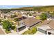 Aerial view of a home nestled in a residential neighborhood with lush greenery and solar panels on neighboring homes at 14434 Scottburgh Glen Dr, Wimauma, FL 33598