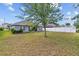 Spacious backyard featuring a well-maintained lawn and a white privacy fence, perfect for outdoor activities at 14434 Scottburgh Glen Dr, Wimauma, FL 33598