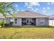 Spacious backyard with covered patio, grill and ample lawn at 14434 Scottburgh Glen Dr, Wimauma, FL 33598