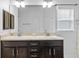 Bright bathroom with double sinks, dark cabinets, and ample counter space at 14434 Scottburgh Glen Dr, Wimauma, FL 33598