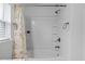 Clean bathroom featuring a white tub and shower combination with updated fixtures at 14434 Scottburgh Glen Dr, Wimauma, FL 33598