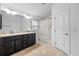 Bathroom featuring a double vanity with dark cabinets, tile flooring and shower curtain at 14434 Scottburgh Glen Dr, Wimauma, FL 33598