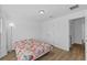 Bedroom featuring wood-look floors, closet and doorway at 14434 Scottburgh Glen Dr, Wimauma, FL 33598
