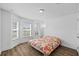 Bright bedroom featuring wood-look floors and a large window at 14434 Scottburgh Glen Dr, Wimauma, FL 33598