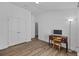 Bedroom featuring wood-look floors, closet, desk, and lamp at 14434 Scottburgh Glen Dr, Wimauma, FL 33598