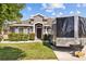 Charming home exterior with well-maintained landscaping and a covered front entry at 14434 Scottburgh Glen Dr, Wimauma, FL 33598