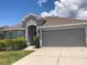 Charming single-story home featuring a two-car garage, well-maintained landscaping, and a welcoming entrance at 14434 Scottburgh Glen Dr, Wimauma, FL 33598