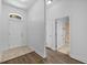 Bright hallway with tile flooring, leading to a bathroom and other areas of the home at 14434 Scottburgh Glen Dr, Wimauma, FL 33598