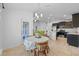 Bright kitchen featuring stainless steel appliances, tile floors, and breakfast nook at 14434 Scottburgh Glen Dr, Wimauma, FL 33598