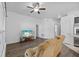 Living room with reclining chair, ceiling fan, and tv at 14434 Scottburgh Glen Dr, Wimauma, FL 33598