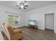 Living room with reclining chair, ceiling fan, and tv at 14434 Scottburgh Glen Dr, Wimauma, FL 33598
