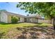 A fenced backyard with a screened-in lanai connected to a home's rear entry door at 16139 Villa Dr, Hudson, FL 34667
