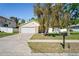 Charming single-story home with stone accents, well-maintained lawn, and attached two-car garage at 16139 Villa Dr, Hudson, FL 34667