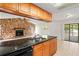Stylish kitchen overlooking the living area, stone accent wall and a sliding door at 16139 Villa Dr, Hudson, FL 34667