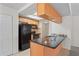 Well-equipped kitchen with black appliances, tile backsplash, and a breakfast bar at 16139 Villa Dr, Hudson, FL 34667