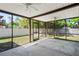 View of screened lanai with ceiling fans overlooking the backyard at 16139 Villa Dr, Hudson, FL 34667