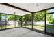 View of screened lanai with ceiling fan overlooking a fenced yard at 16139 Villa Dr, Hudson, FL 34667