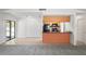 Open-concept living area flowing into kitchen, featuring modern appliances and ample space at 16139 Villa Dr, Hudson, FL 34667