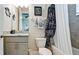 Well-lit bathroom featuring vanity with granite countertop and a tub shower with stylish curtain at 16612 5Th E Ave, Bradenton, FL 34212