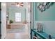 Luxurious bathroom featuring a tiled tub, turquoise walls, and themed decor at 16612 5Th E Ave, Bradenton, FL 34212