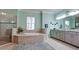 Elegant bathroom featuring a soaking tub, double vanity, and glass-enclosed shower at 16612 5Th E Ave, Bradenton, FL 34212