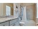 Bathroom featuring vanity with granite countertop, a bathtub with shower and a window with blinds at 16612 5Th E Ave, Bradenton, FL 34212