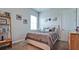 Neutral bedroom featuring a queen-sized bed with gray bedding, complemented by wooden furniture and decor at 16612 5Th E Ave, Bradenton, FL 34212