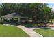 View of a shaded community park gazebo with picnic tables, benches, and walking path at 16612 5Th E Ave, Bradenton, FL 34212