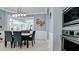 Elegant dining area with modern lighting, a decorative crab wall hanging, and pool views at 16612 5Th E Ave, Bradenton, FL 34212